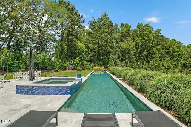 view of swimming pool featuring a patio and a pool with connected hot tub