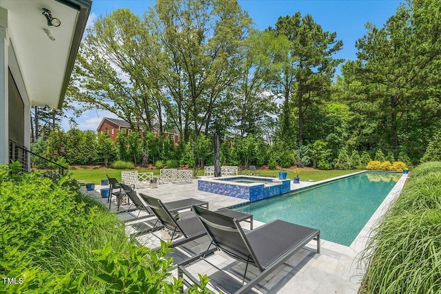 view of swimming pool with a patio area and a pool with connected hot tub