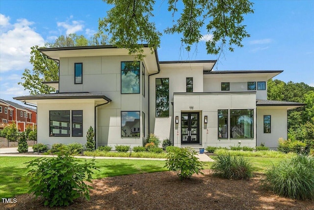 view of front of house featuring stucco siding and a front yard