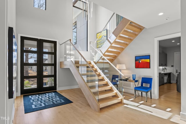 foyer entrance featuring recessed lighting, stairs, baseboards, and wood finished floors