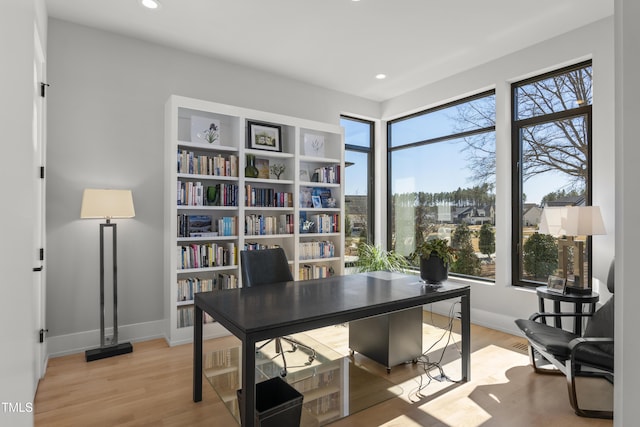 office area with recessed lighting, light wood-type flooring, and baseboards