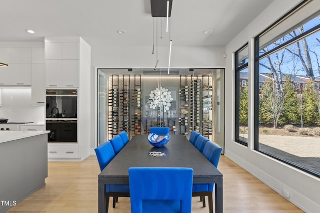 dining space with recessed lighting, baseboards, and light wood-style floors