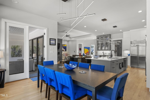 dining space featuring light wood-style flooring and recessed lighting