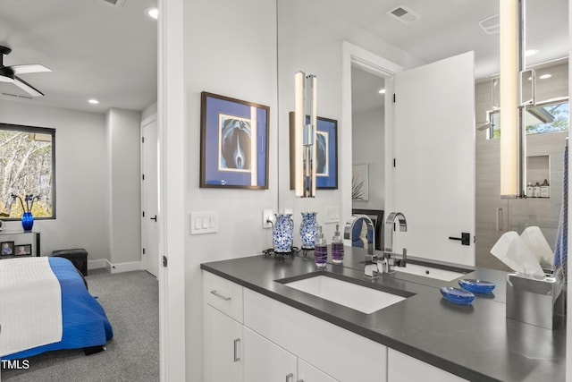 bathroom featuring a wealth of natural light, visible vents, vanity, and ceiling fan