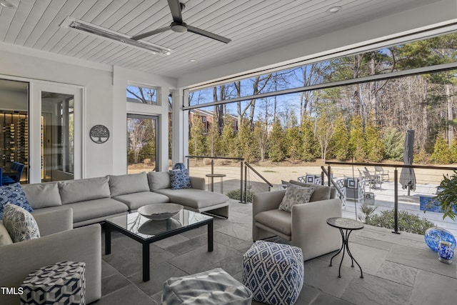 sunroom with wood ceiling and ceiling fan