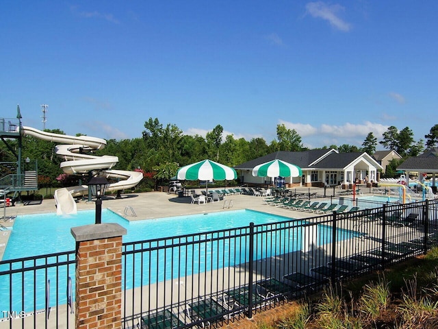 community pool featuring a patio area and fence