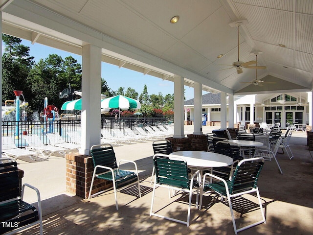 view of patio / terrace with ceiling fan, outdoor dining space, and fence