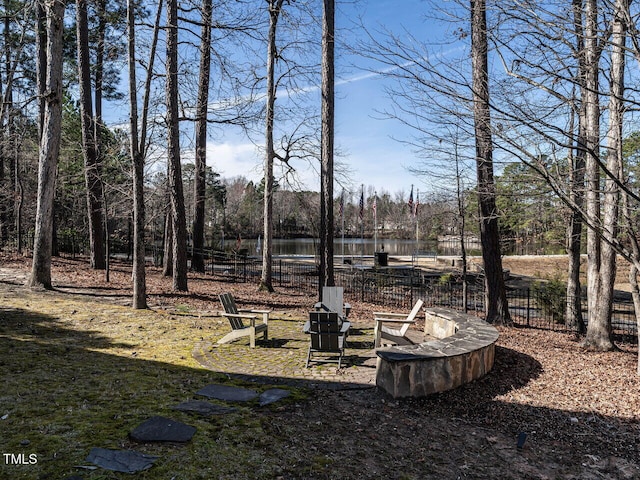 view of yard with a water view and fence