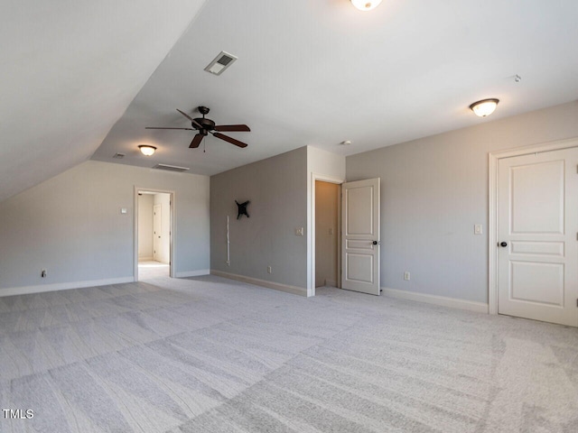 interior space with baseboards, visible vents, and light colored carpet