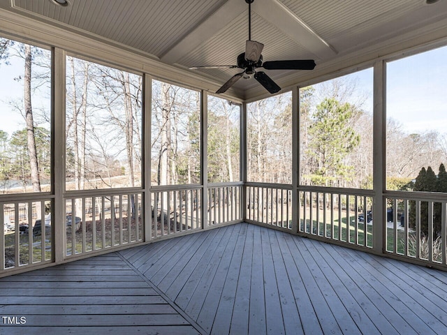 unfurnished sunroom with a ceiling fan