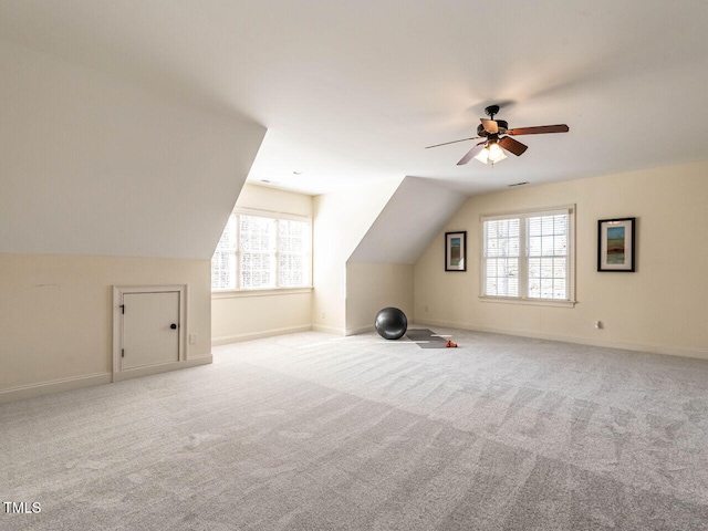 bonus room with light colored carpet, vaulted ceiling, and baseboards