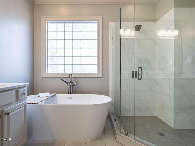 bathroom featuring a stall shower, plenty of natural light, a freestanding tub, and vanity