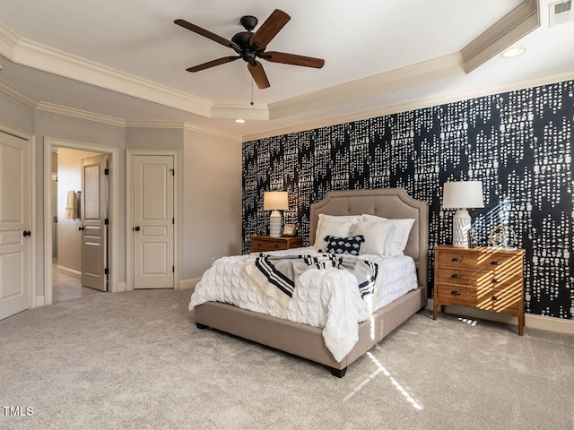 bedroom featuring carpet floors, crown molding, a raised ceiling, visible vents, and baseboards