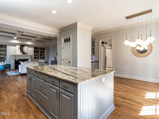 kitchen featuring open floor plan, coffered ceiling, dark wood finished floors, and a center island