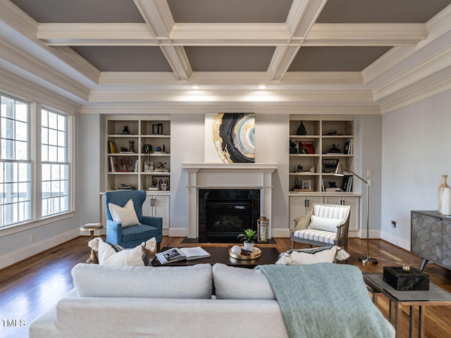 living room featuring dark wood-style floors, a high end fireplace, coffered ceiling, and ornamental molding