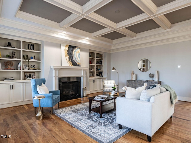 living area featuring a fireplace with flush hearth, beamed ceiling, coffered ceiling, and wood finished floors