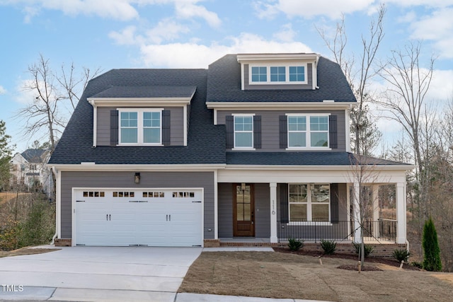view of front of property with covered porch, concrete driveway, and a shingled roof