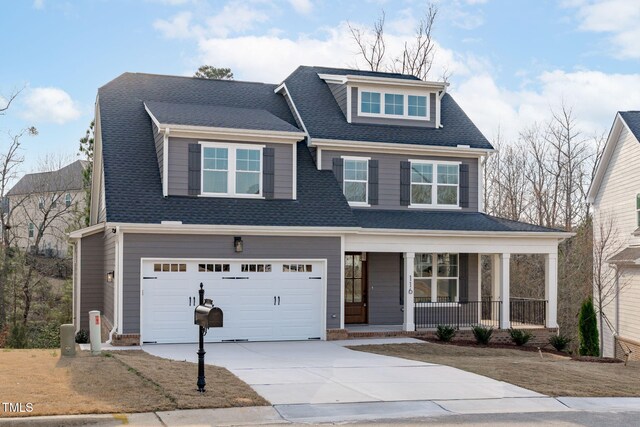 view of front of house featuring concrete driveway, covered porch, and roof with shingles