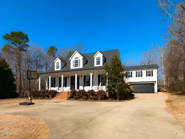 view of front of property with a porch, driveway, and a garage