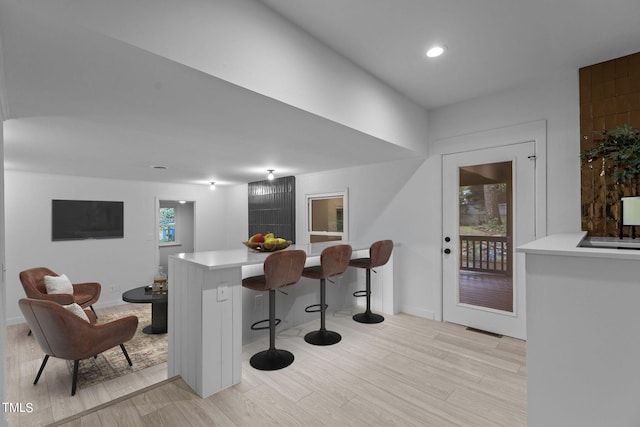 bar featuring light wood-style flooring, visible vents, baseboards, and recessed lighting