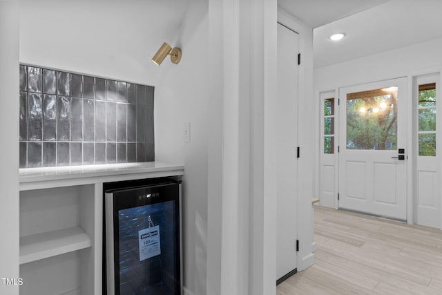 interior space featuring beverage cooler, light wood finished floors, and recessed lighting