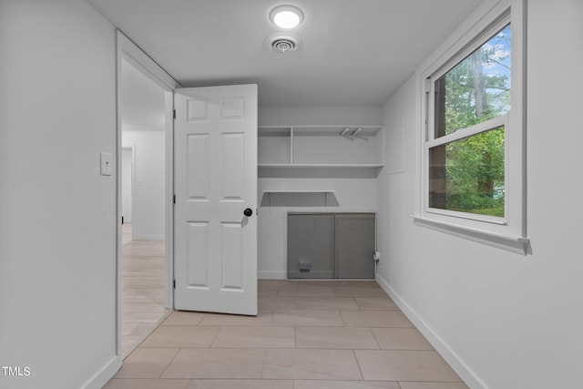 washroom featuring light tile patterned floors, visible vents, and baseboards