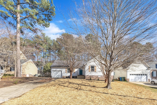 view of front of property with driveway, a garage, and a front lawn