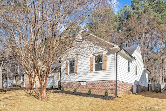 view of side of property featuring a yard and crawl space