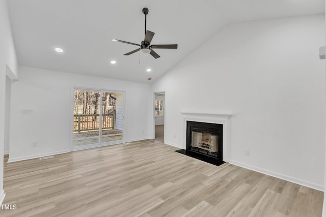 unfurnished living room with recessed lighting, a fireplace with flush hearth, a ceiling fan, baseboards, and light wood-type flooring