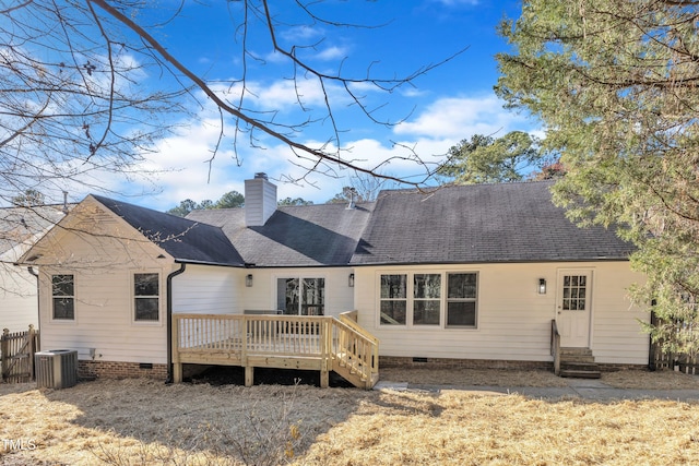 rear view of house with a chimney, a shingled roof, entry steps, crawl space, and a deck