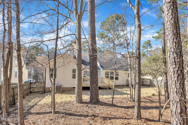 view of yard with cooling unit, a fenced backyard, and a deck