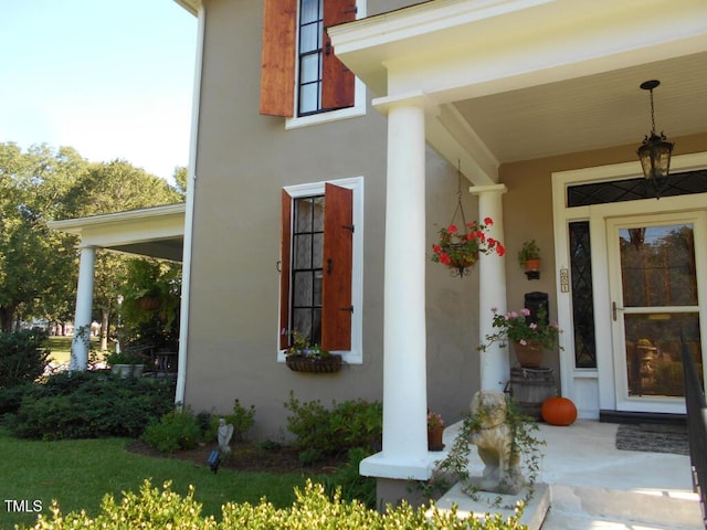 doorway to property featuring stucco siding