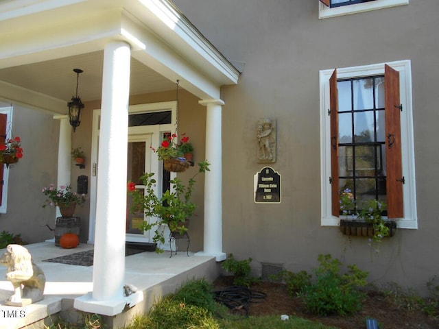 doorway to property featuring stucco siding