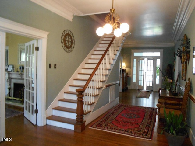 foyer entrance with stairway, dark wood-style flooring, and crown molding