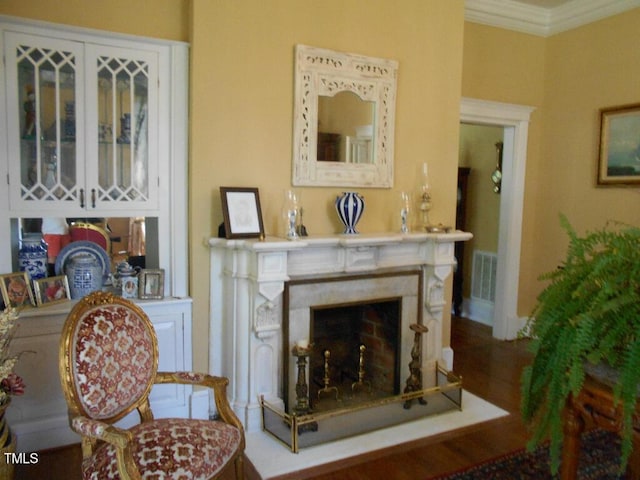 living area featuring visible vents, a high end fireplace, and crown molding