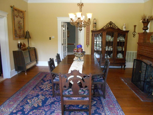 dining room featuring visible vents, dark wood finished floors, and ornamental molding