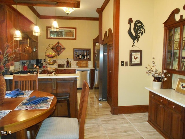 kitchen with light countertops, appliances with stainless steel finishes, a peninsula, and pendant lighting