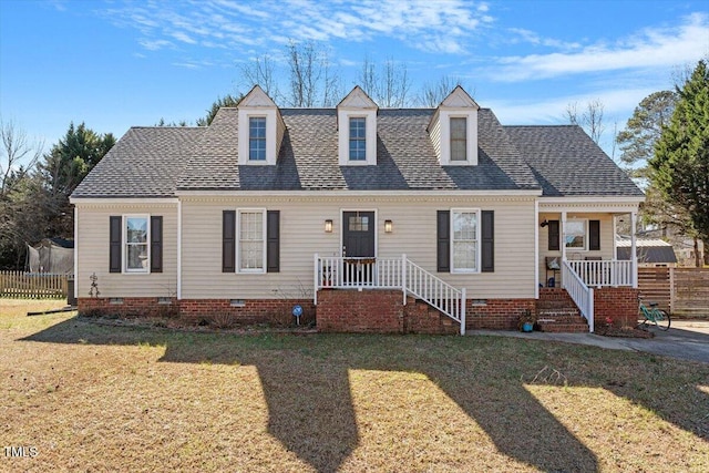 cape cod-style house with crawl space, a shingled roof, and a front lawn