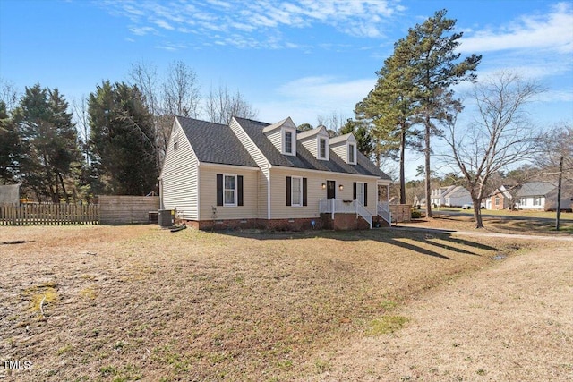 cape cod home featuring crawl space, fence, central AC, and a front yard