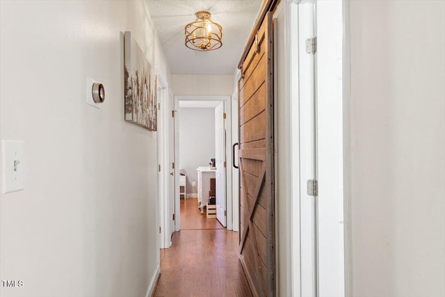 hall featuring dark wood-style flooring and baseboards