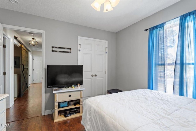 bedroom featuring dark wood-style floors and a textured ceiling