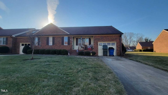 ranch-style home featuring a garage, driveway, a front lawn, and brick siding