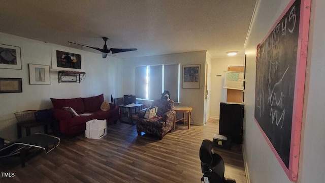 living area featuring ceiling fan, a textured ceiling, and wood finished floors