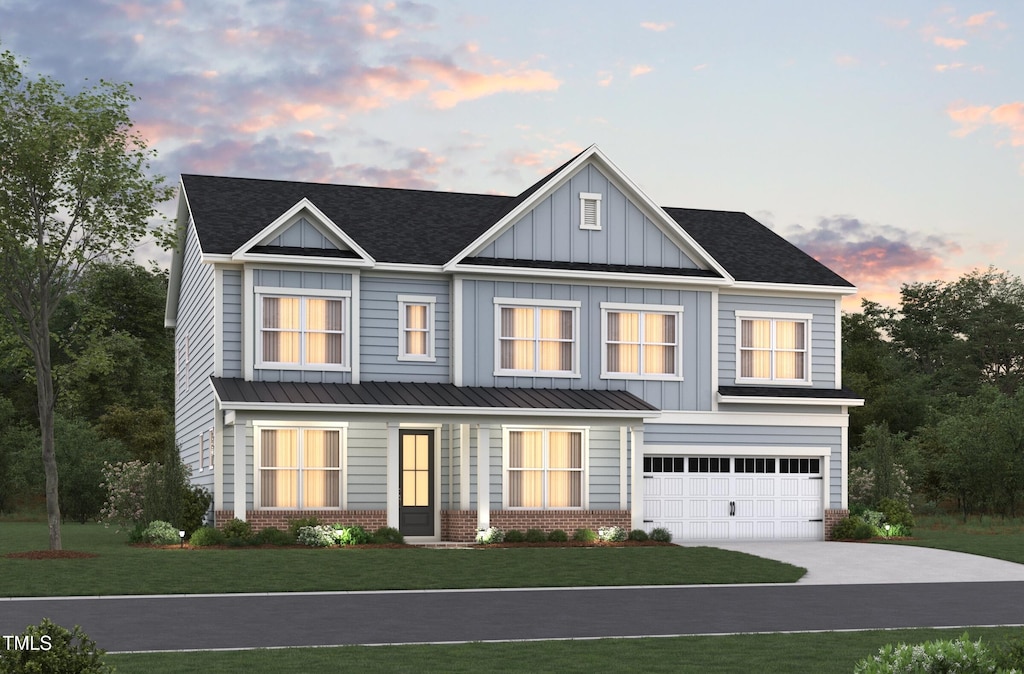 view of front facade featuring a garage, brick siding, driveway, a front lawn, and board and batten siding