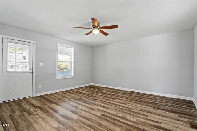 foyer entrance featuring ceiling fan, wood finished floors, and baseboards