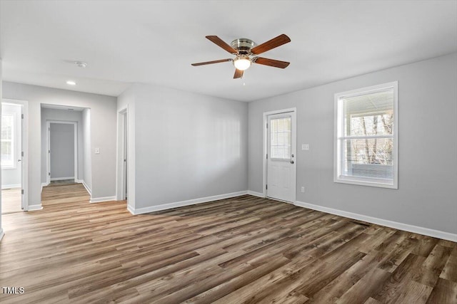 interior space featuring dark wood-style flooring and baseboards