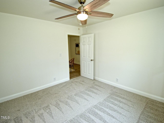 unfurnished room featuring carpet floors, baseboards, and a ceiling fan