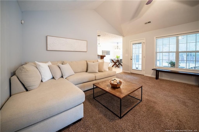 living room with lofted ceiling, carpet, visible vents, and baseboards