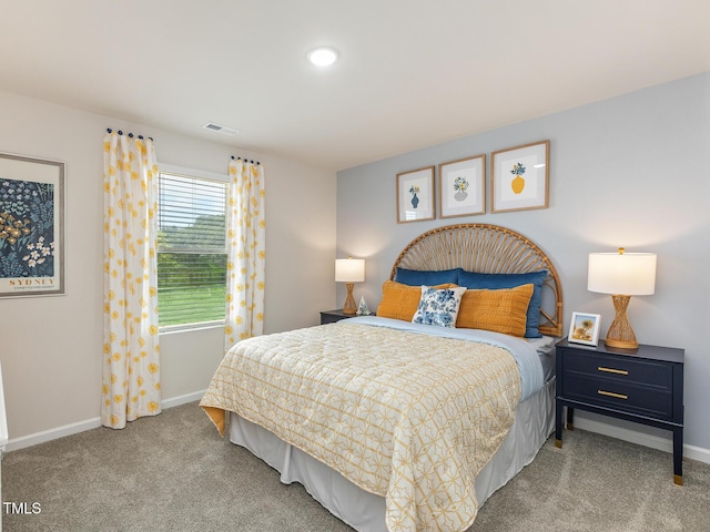 bedroom with carpet, visible vents, and baseboards