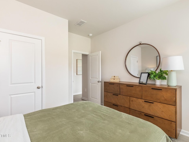 bedroom featuring visible vents and baseboards